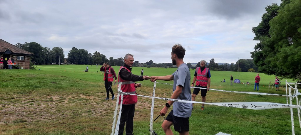 Finish tokens being handed out by William and Stephen, with Number Checker Sam heading over to find out the name and finish position of this runner.