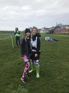Carlyn and Livvy standing together to the side of the finish