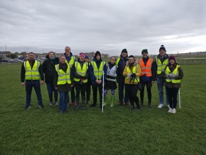 13 of the volunteer team gathered together in front of the start/finish, wearing high vis jackets