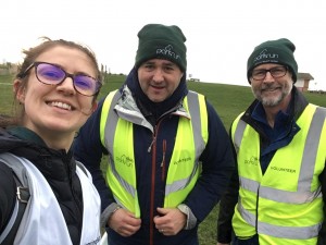 Livvy, Julian and Mike smiling in a seflie, wearing high vis jackets