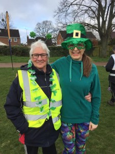 Two women with green Irish themed accessories